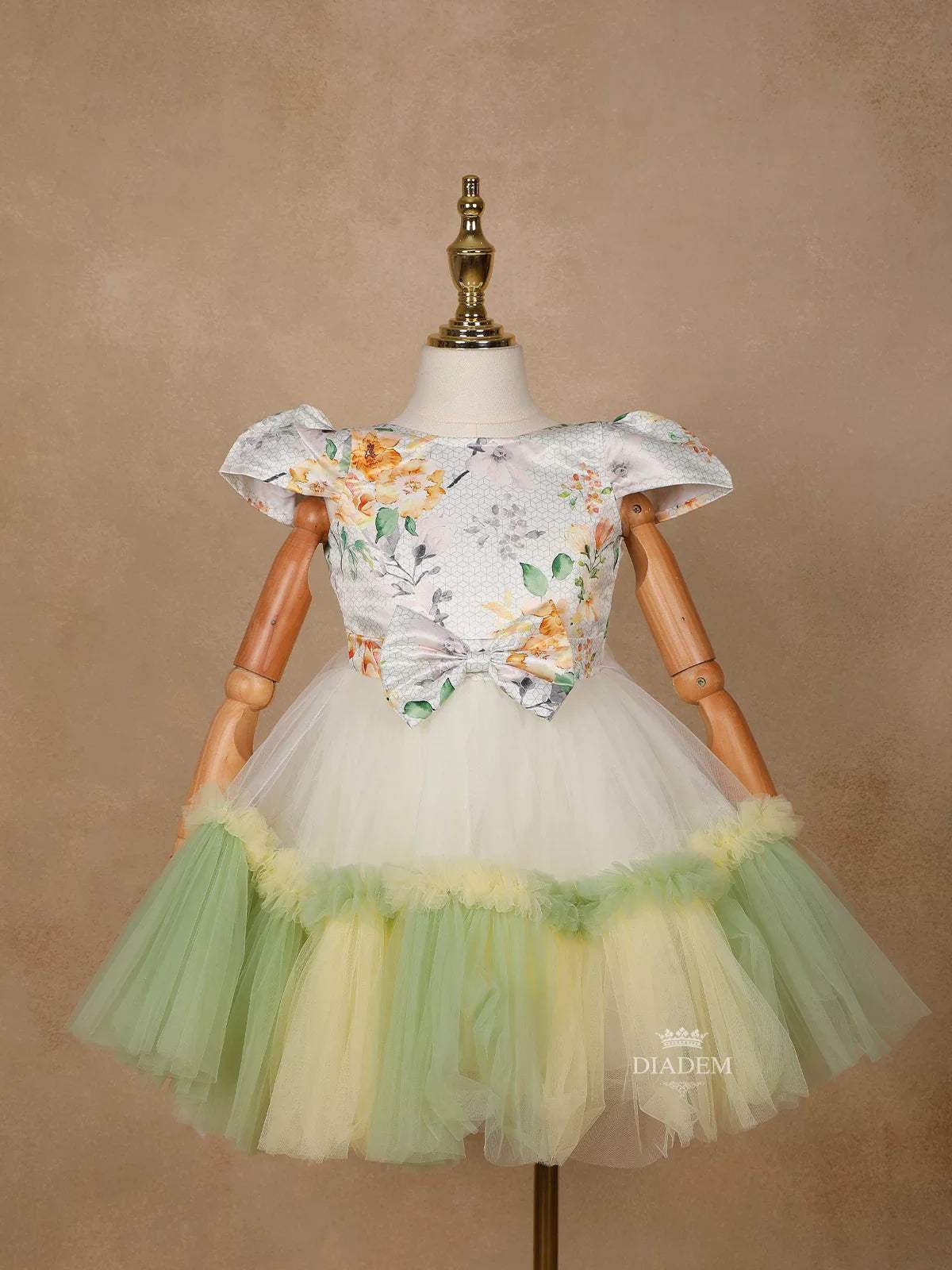 Light Green Satin with Net Frilled Gown Adorned with Floral Prints and Attached Bow - Diadem