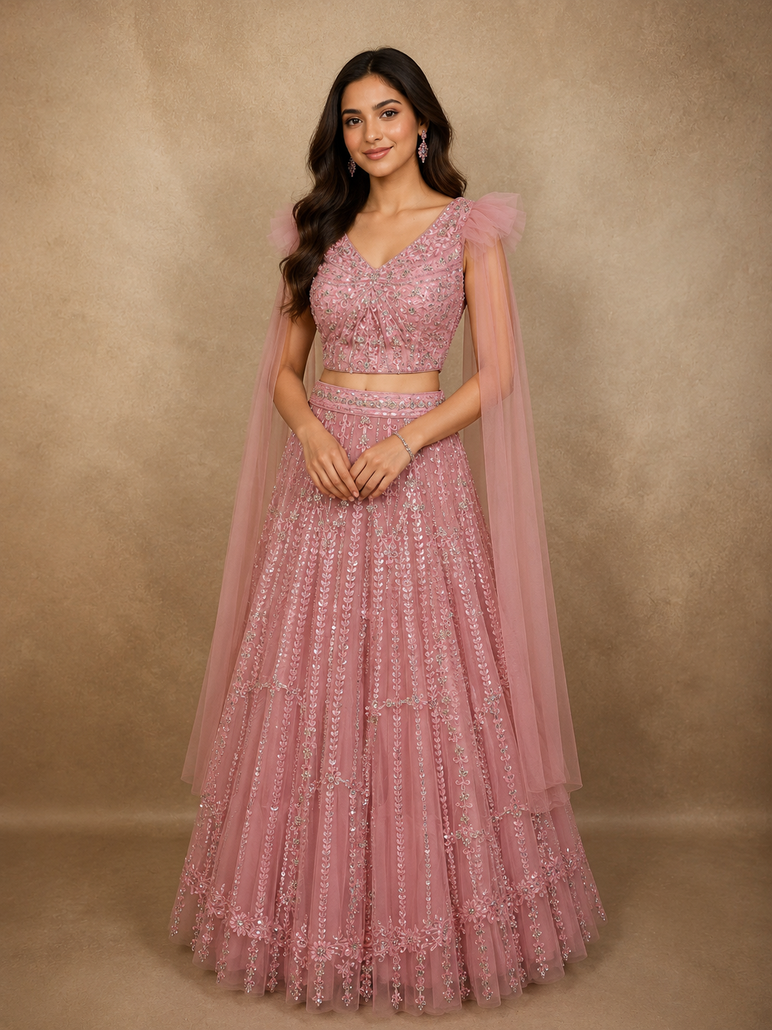 Soft Dusty Rose Pink Heavy Sequins Embroidered Design Net Lehenga Set with Cape Sleeves | Diadem Soft Dusty Rose Pink Heavy Sequins Embroidered Design Net Lehenga Set with Cape Sleeves | Diadem