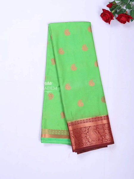 Green Art Silk Saree with Paisley Motif on the body and Contrast Zari Border - Diadem