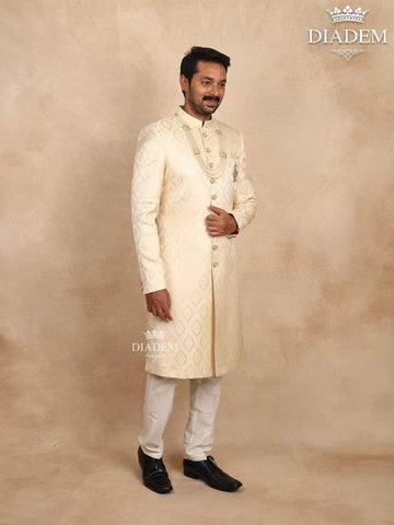 Cream Raw Silk Sherwani Suit Adorned with Floral Embroidery, Paired with Brooch and Bead Mala - Diadem