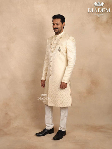 Cream Raw Silk Sherwani Suit Adorned with Floral Embroidery, Paired with Brooch and Bead Mala - Diadem