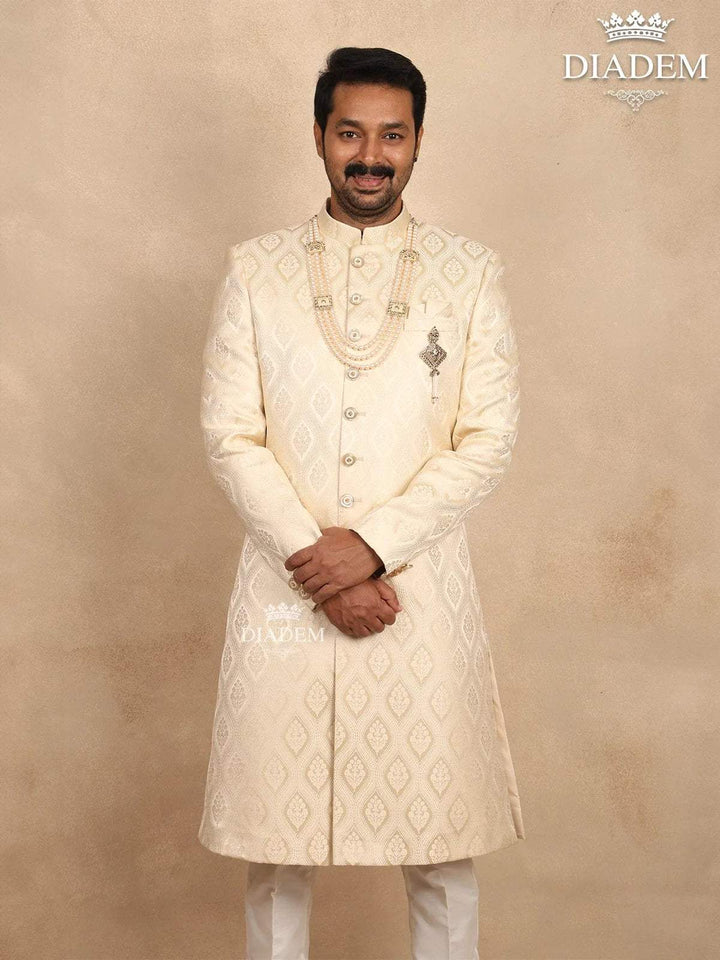 Cream Raw Silk Sherwani Suit Adorned with Floral Embroidery, Paired with Brooch and Bead Mala - Diadem