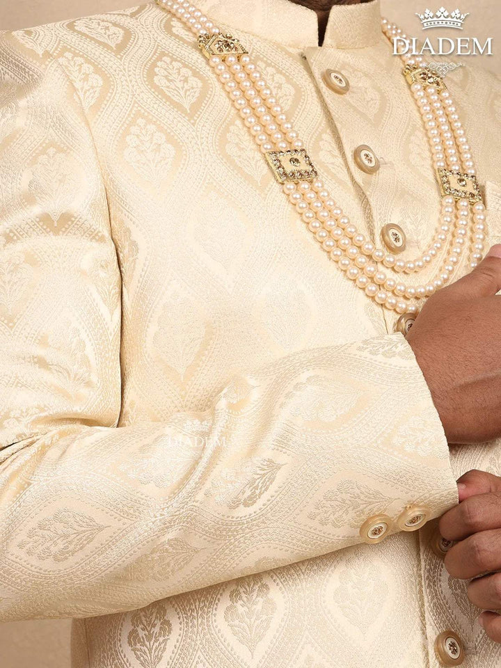 Cream Raw Silk Sherwani Suit Adorned with Floral Embroidery, Paired with Brooch and Bead Mala - Diadem