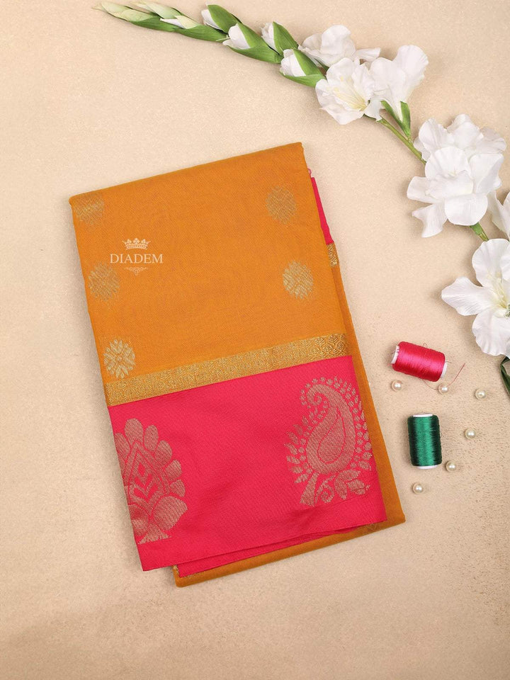 Yellow Silk cotton Saree with floral motif design on the body and contrast pink zari border - Diadem