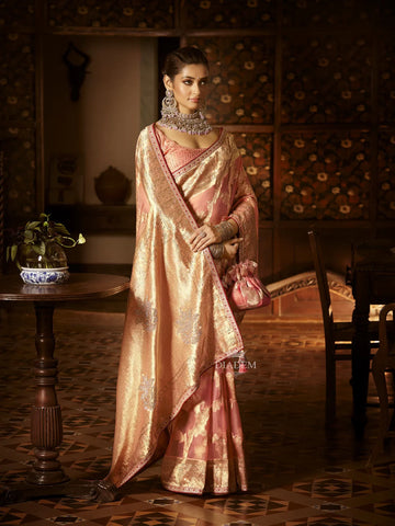 Peach Banarasi Organza Saree Embellished with Floral Zari, Stonework and Designer Border along with Potli Bag - Diadem