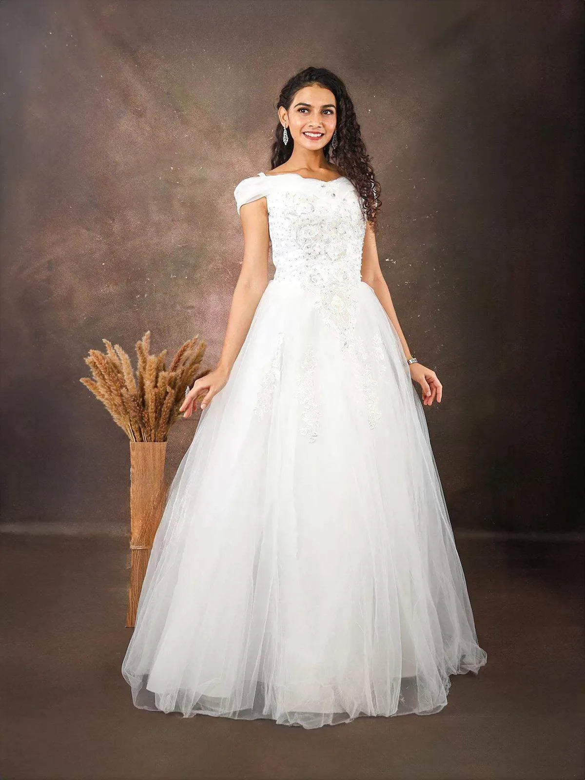 Discover elegance in our white net gown embellished with floral threadwork embroidery and sequins at Diadem Find your perfect dress now!