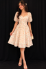 Ivory Frock Adorned with Floral and Ruffled Design