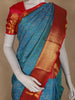 Peacock Blue Floral Woven Pure Kanchipuram Silk Saree With Contrast Border