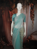 Teal Blue Heavy Sequins and Beads Embroidered Design Net Saree with Scalloped Border