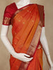 Warm Burnt Orange Floral Butta Woven Design Pure Kanchipuram Silk Saree with Contrast Peacock Zari Border